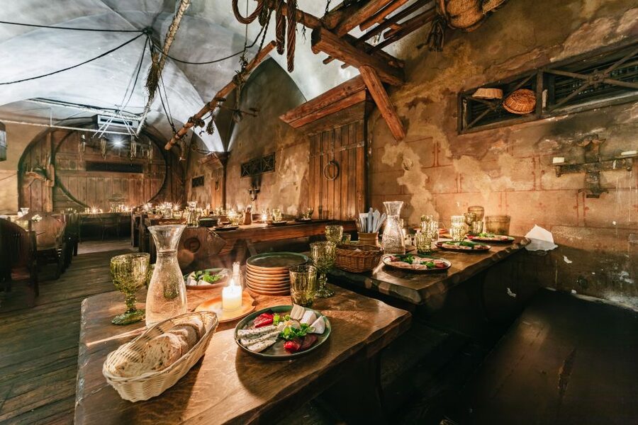 Prague: Medieval Dinner with Unlimited Drinks - Shared tables, tight seating, and low light