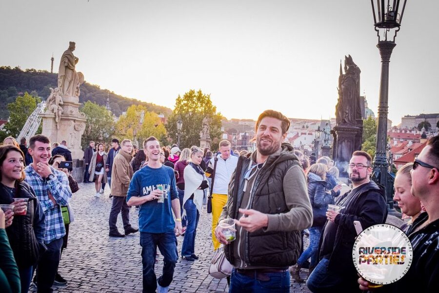 Prague Riverside Parties Tour - Crossing Charles Bridge with the party still moving