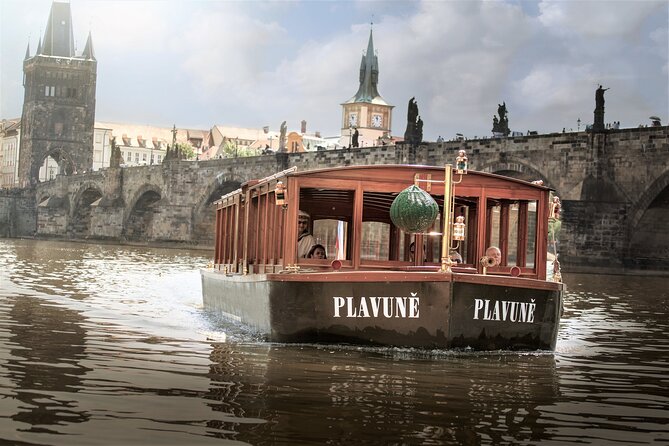 Prague Walking Tour with River Boat Cruise and Lunch - 6 hours - Crossing Charles Bridge and riding uphill